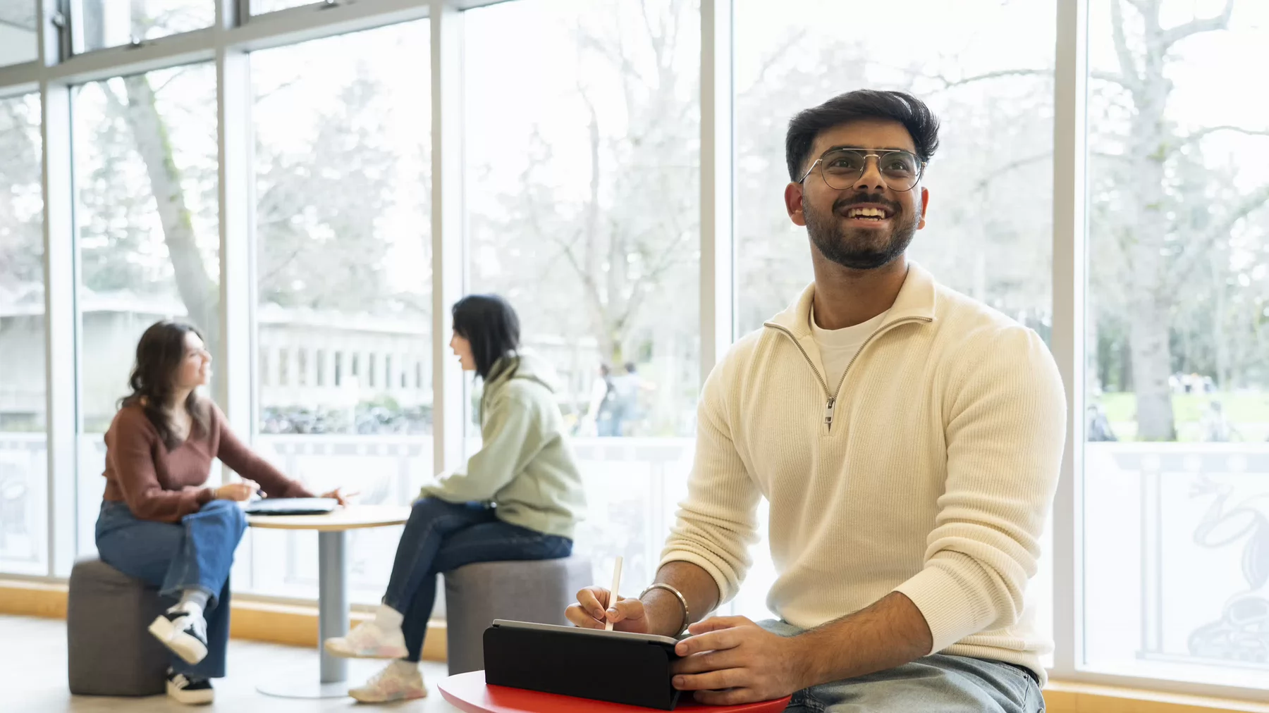 A student sitting at a desk in the library.