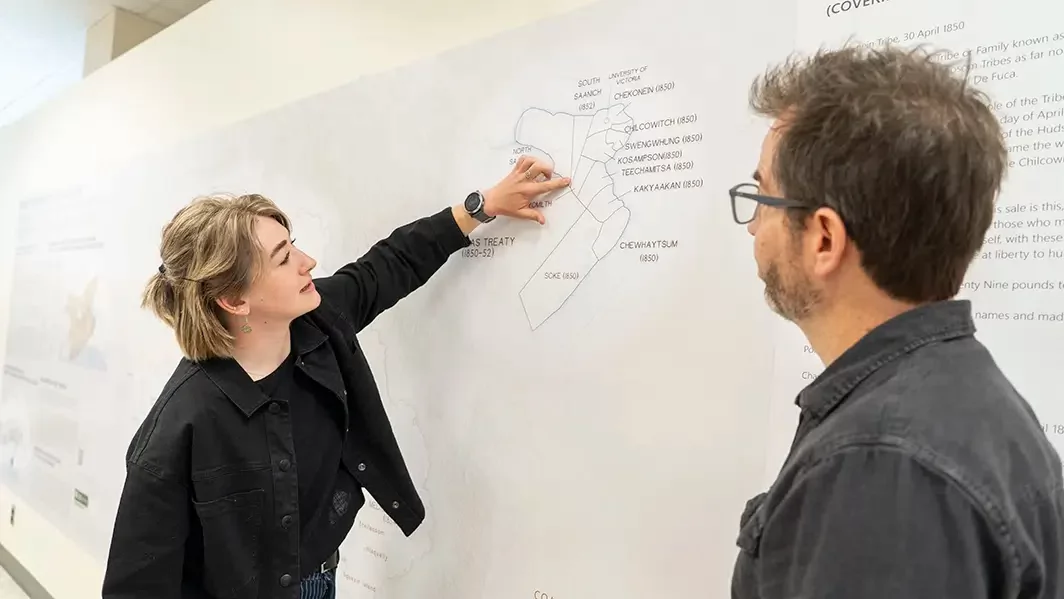 Two people look at a map.