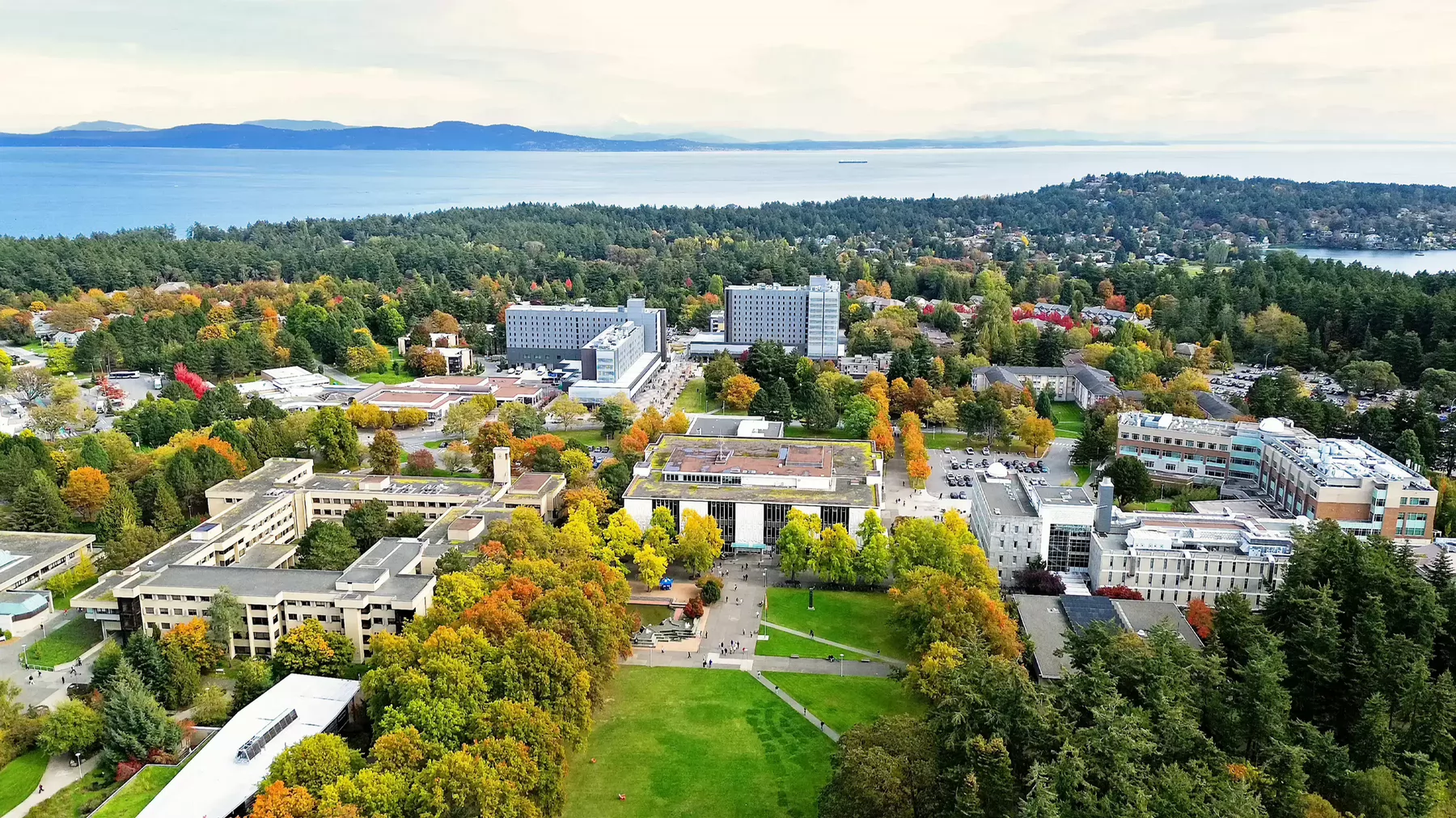 An aerial view of the UVic campus with the ocean in the background.