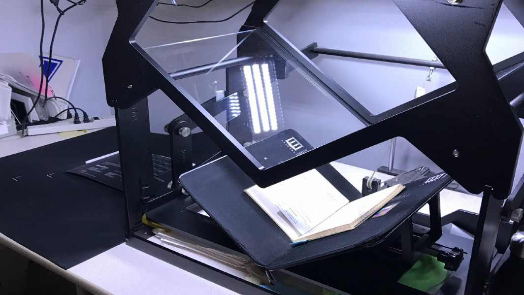 A UVic Library scanner scanning the contents of an old book