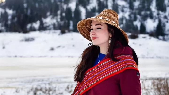 Janna Wale stands outside in a snow covered landscape.