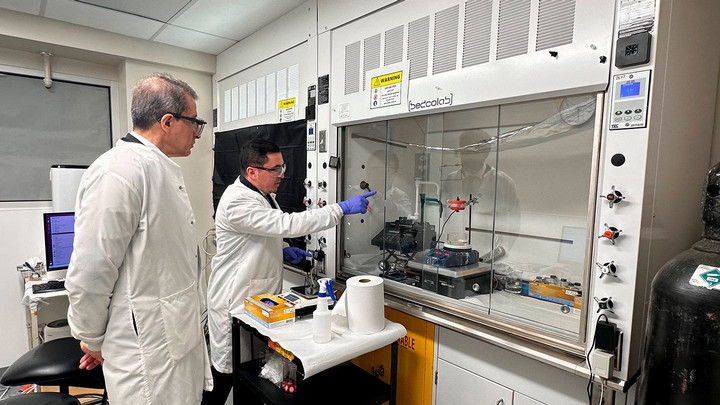 NSERC President Alejandro and Makhsud Saidaminov look at crystal synthesizing technology in the lab.