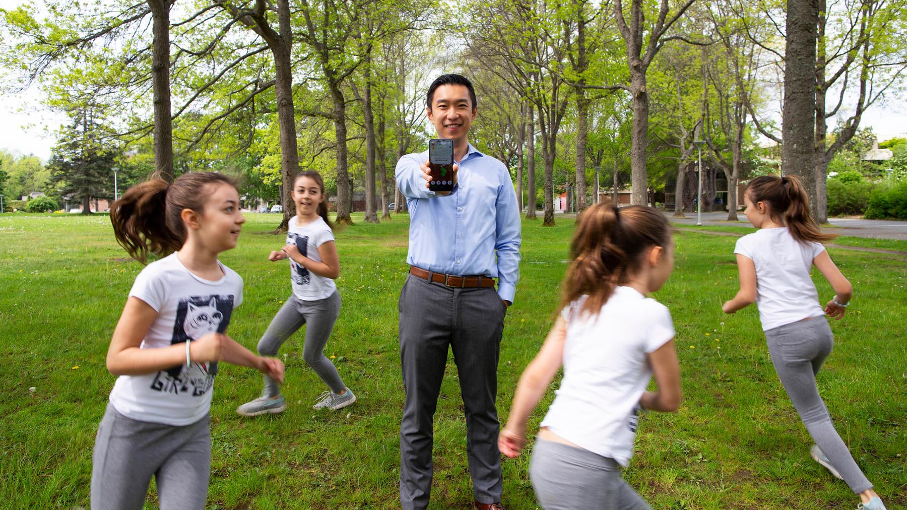 Sam Liu holding phone