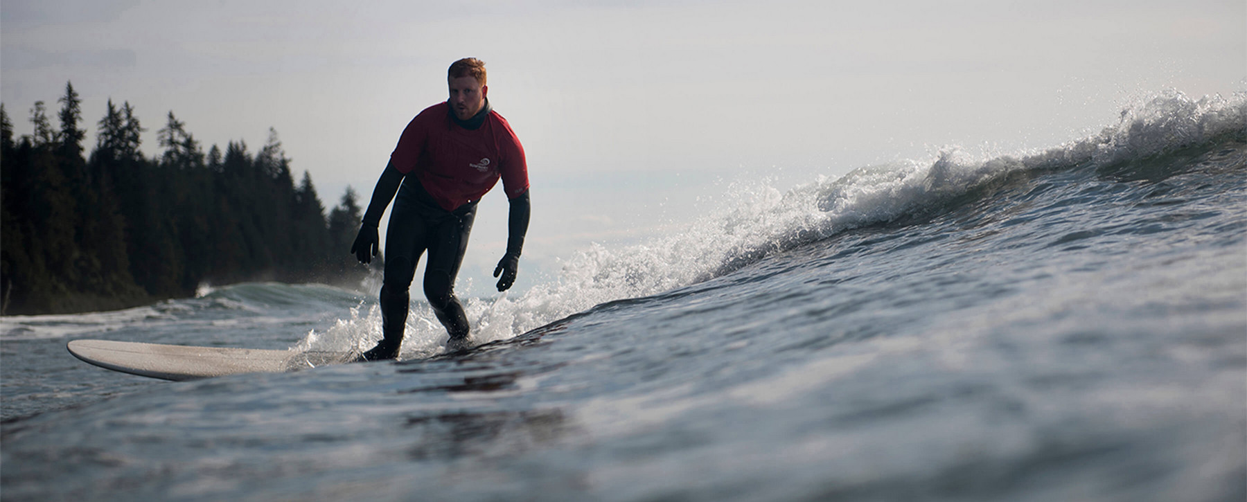 Man in wetsuit surfing.