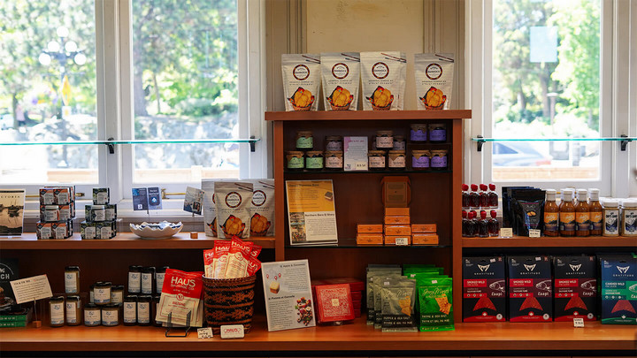 A shop display of various jars, bags and packages of food. 
