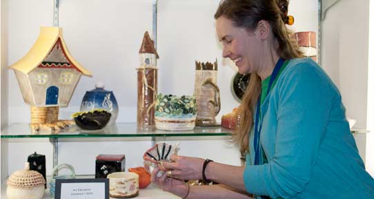 instructor showing ceramic work