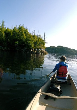 Kira commuting by canoe