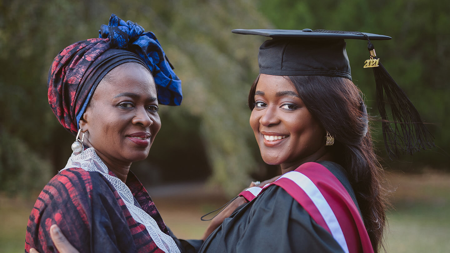 Yinka Fasheun in her graduation gown with her mom 