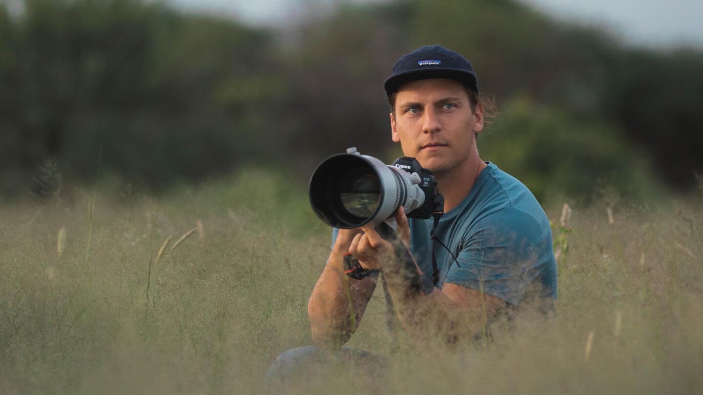 Photographer Chase Teron in a field with his camera