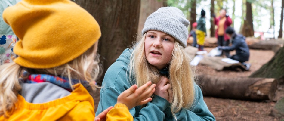 Student with school kids at Victoria Nature School