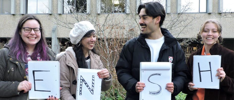 students holding  a letter for the new acronym "ENSH" 