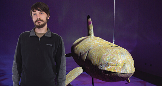 Hash standing next to his whale sculpture
