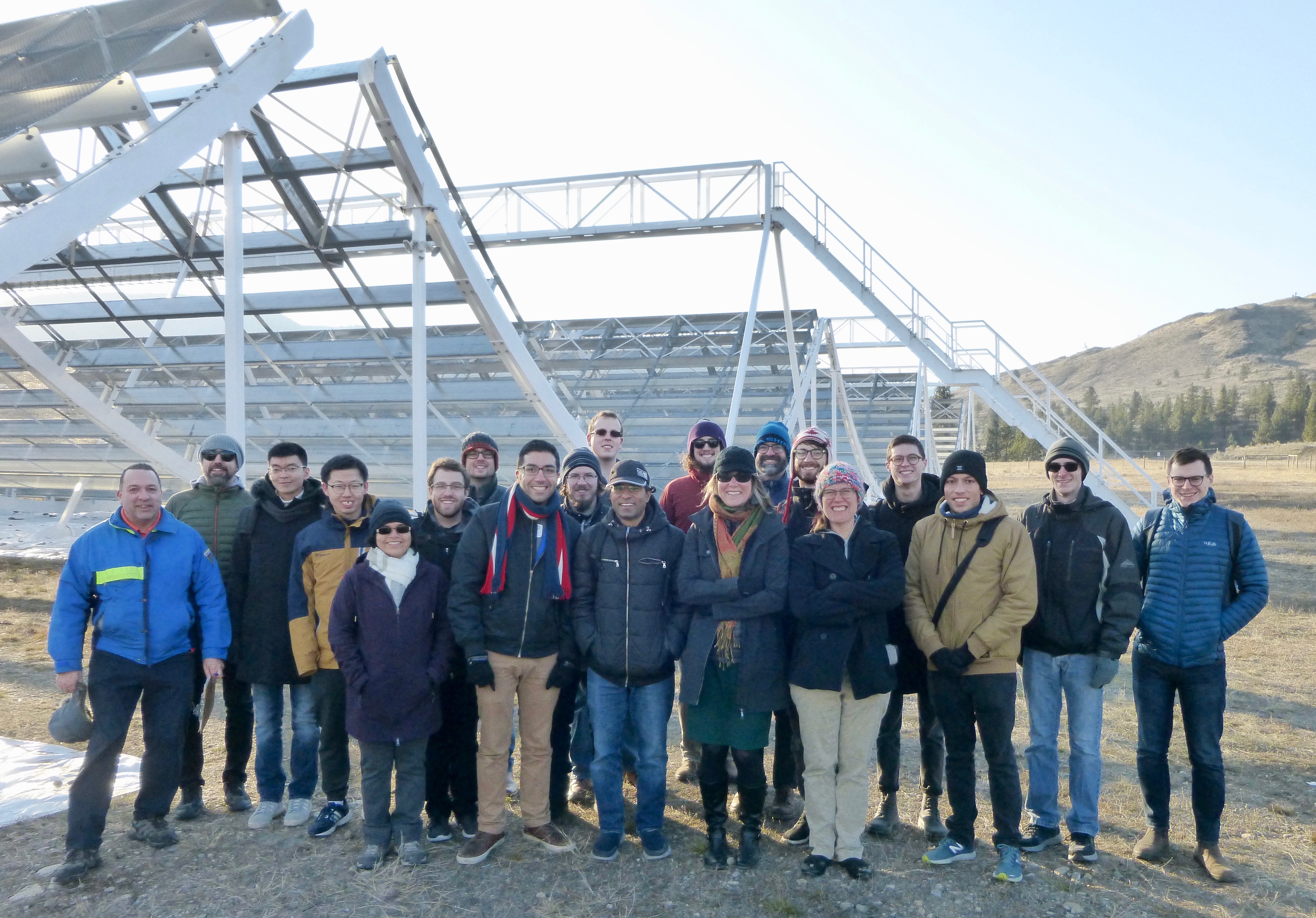 Group shot of NTCO students and others in front of the CHIME telescope