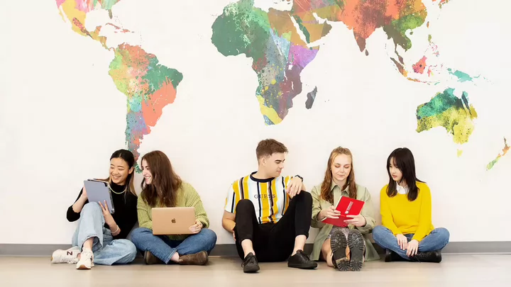 group of students with map in background